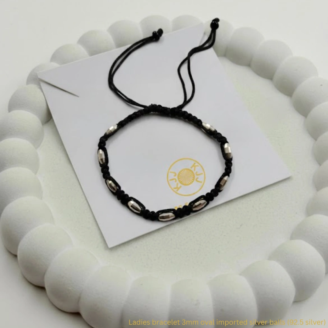 At Kanhaji Jewels (KJJ), we believe your baby deserves the purest protection. This unique Nazariya set features vibrant blue evil eye charms paired with delicate 2.5mm imported silver balls, creating a beautiful contrast against the traditional black beads. Crafted from certified 92.5 Sterling Silver, these bracelets are more than just jewelry—they are a symbol of love and safety. The blue evil eye is globally recognized for its power to ward off bad luck and negativity, while the silver beads add a premium, lasting shine that is gentle on your little one's skin. Key Highlights: Certified 92.5 Sterling Purity: Every silver bead is made of guaranteed high-purity silver, ensuring a hypoallergenic and durable finish. 2.5mm Imported Silver Balls: Features precision-crafted silver beads that offer a subtle yet sophisticated sparkle. Enhanced Evil Eye Protection: Adorned with multiple blue evil eye charms to provide maximum spiritual shielding for your baby. Soft & Adjustable Fit: Hand-strung on a comfortable black thread with a traditional red and black tassel finish for an easy, adjustable fit. The Perfect Blessing: An ideal gift for birth celebrations, naming ceremonies, or as a protective daily accessory for infants and toddlers. Product Specifications: Brand: Kanhaji Jewels (KJJ) Material: 92.5 Sterling Silver & Premium Protective Charms Silver Ball Size: 2.5mm (Imported) Design: Blue Evil Eye & Silver Bead Fusion Quantity: 1 Pair (Set of 2)